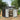 Metal garden storage shed, open double doors showing shelves and tools inside
