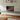 Recessed electric fireplace in wall opening, black frame, glowing flame display