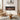 Wall-mounted electric fireplace with black surround and orange flame screen