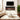 Recessed electric fireplace with black frame and glowing orange flame insert