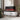 Recessed electric fireplace with black firebox and marble surround, red flame effect