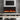 Recessed electric fireplace with glowing flames and black glass front