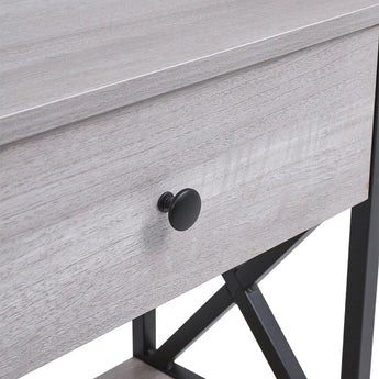 Close-up of drawer front and round knob on rustic grey console table