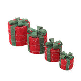 Set of four Christmas gift box decorations, red boxes with green ribbon bows