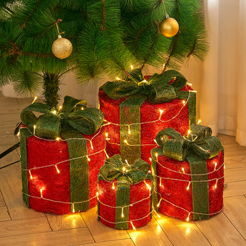 Set of four LED Christmas gift box decorations, red boxes with green ribbon, glowing