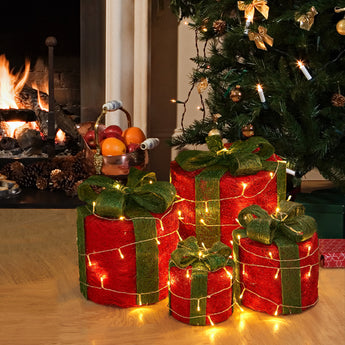Set of four LED Christmas gift box decorations, red boxes with green ribbon, glowing