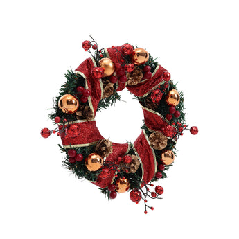 Christmas wreath with red velvet ribbon, pine tips, berries, and gold baubles