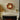 Decorative hanging Christmas wreath with red ribbon and gold ornament balls