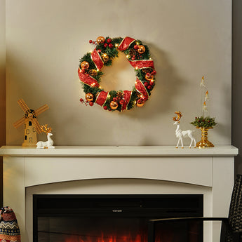 Decorative hanging Christmas wreath with red ribbon and gold ornament balls