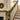 Gold holiday garland with pine greenery, gold baubles, and warm LED lights on staircase rail