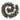 Christmas wreath with pine branches, red ribbon bows, and red baubles, on white background