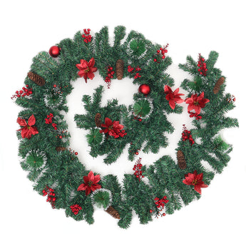 Christmas wreath with pine branches, red ribbon bows, and red baubles, on white background
