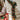 Tall Christmas garland with pine greenery, red ornaments, and plaid bows on stair post