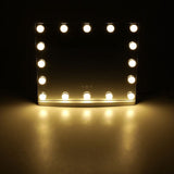 LED vanity mirror with warm-lit bulbs lining the rectangular glass frame