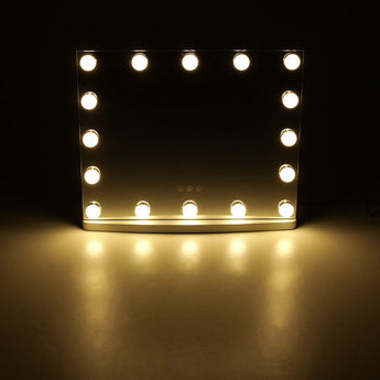 LED vanity mirror with warm-lit bulbs lining the rectangular glass frame