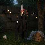 Black hanging witch decoration with skull face, pointed hat, and tattered veil sleeves