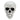 White plastic skull tabletop ornament, front view with teeth and dark eye sockets