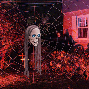 Hanging skull ornament with long gray strands and glowing blue eyes