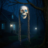 Hanging Halloween skull decoration with glowing eyes, gray hair strands