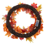 Autumn leaf wreath on black wire ring with warm lights and decorative fall tags