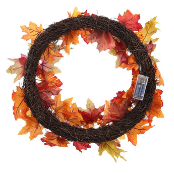 Autumn leaf wreath on black wire ring with warm lights and decorative fall tags