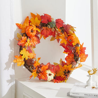 Autumn leaf wreath with glowing warm lights and orange, red, and yellow foliage