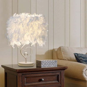White feather table lamp on round base with heart-shaped stand, bedside style