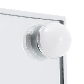 Close-up of a circular LED bulb on the vanity mirror frame
