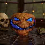 LED light-up pumpkin on a web pattern, blue glowing eyes and carved grin, orange