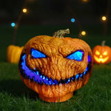 Halloween LED pumpkin with orange jack-o’-lantern carving and bright blue glowing eyes