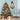 Lighted wreath snowman door decor hanging, plaid hat and burlap bow with warm lights