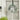 Artificial Christmas wreath with silver ribbon, pine leaves, and white floral ornaments