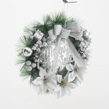 Front view Christmas wreath with silver bow, pine greenery, and white poinsettia accents