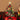Artificial mini tabletop Christmas tree with gold star topper, red bows, multicolor LED lights
