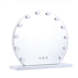 Round frameless vanity mirror with LED bulbs and white tabletop base