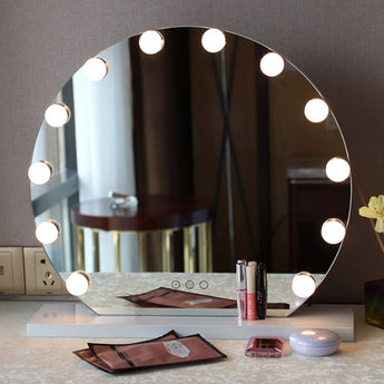 Frameless round makeup mirror with lit LED bulbs and rectangular control buttons