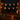 Halloween LED string lights draped across window, jack-o'-lantern face bulb lights