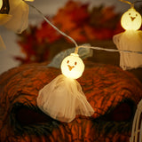 Single glowing ghost LED with round yellow face and white tulle dress on string
