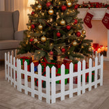 White wooden Christmas picket fence around a decorated tabletop tree