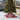 Red Christmas tree collar basket with sparkly bow, lit with warm lights