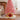Pink Christmas tree collar basket with glittery bow, lit with warm lights