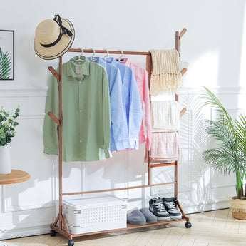 Natural wood bamboo clothes rack with hanging bar, side hooks, and lower storage shelf