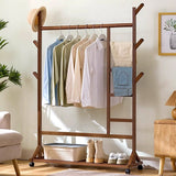Brown bamboo clothes rack with hanging rail, side ladder shelves, rolling bottom shelf