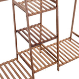 Close view of brown bamboo slatted shelves on a 5-tier clothes rack