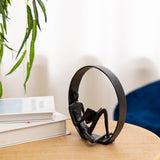 Man reading desk statue with dark circular frame ornament, metal figurine