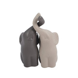 Ceramic couple elephant figurines, dark and light, close view