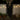 Hanging skeleton ghost figure with red eyes, blond hair strands, and black tattered cloak