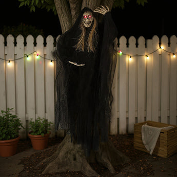 Hanging skeleton ghost figure with red eyes, blond hair strands, and black tattered cloak