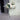 White metal column planter with tall rectangular frame and open grid sides