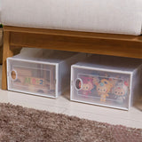 White plastic shoe storage bins with cartoon print and circular handle cutouts, 2-pack view